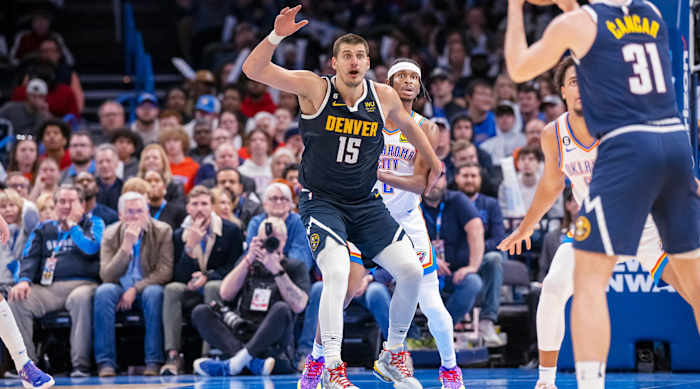 Denver Nuggets center Nikola Jokić jostles for position in the post against Oklahoma City Thunder guard Shai Gilgeous-Alexander.